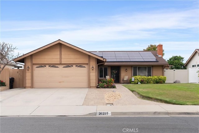 26231 Avenida Calidad, Mission Viejo, CA 92691 - single story home featuring roof mounted solar panels, concrete driveway, a garage, a gate, and a chimney