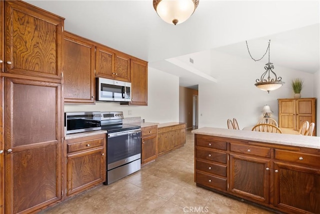 26231 Avenida Calidad, Mission Viejo, CA 92691 - kitchen featuring appliances with stainless steel finishes, brown cabinetry, light countertops, lofted ceiling, and decorative light fixtures