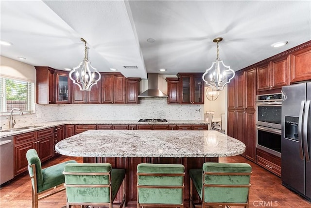 3372 Buckingham Rd, Chino Hills, CA 91709 - kitchen featuring a chandelier, wall chimney exhaust hood, stainless steel appliances, a center island, and recessed lighting