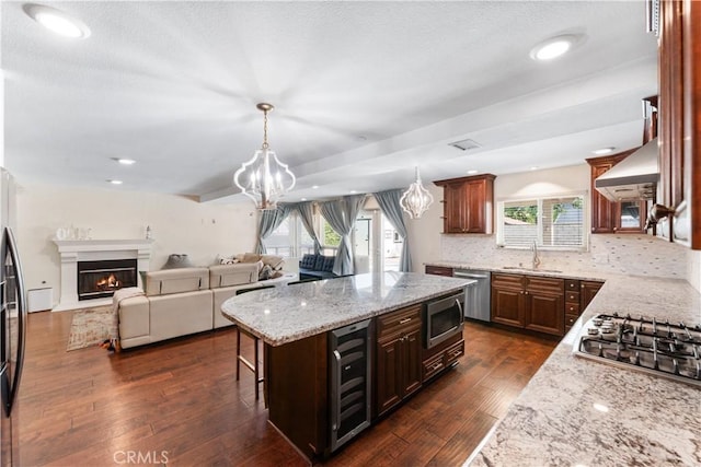 3372 Buckingham Rd, Chino Hills, CA 91709 - kitchen with beverage cooler, appliances with stainless steel finishes, light stone countertops, a chandelier, and a kitchen island
