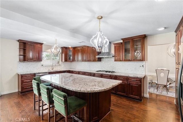 3372 Buckingham Rd, Chino Hills, CA 91709 - kitchen with wall chimney exhaust hood, dark wood-style floors, a kitchen island, and decorative backsplash