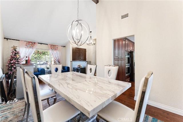 3372 Buckingham Rd, Chino Hills, CA 91709 - dining area featuring a chandelier, dark wood-style flooring, and high vaulted ceiling