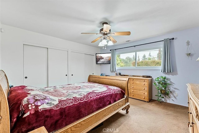 7669 Granby Ave, Rancho Cucamonga, CA 91730 - bedroom featuring two closets, light carpet, and a ceiling fan