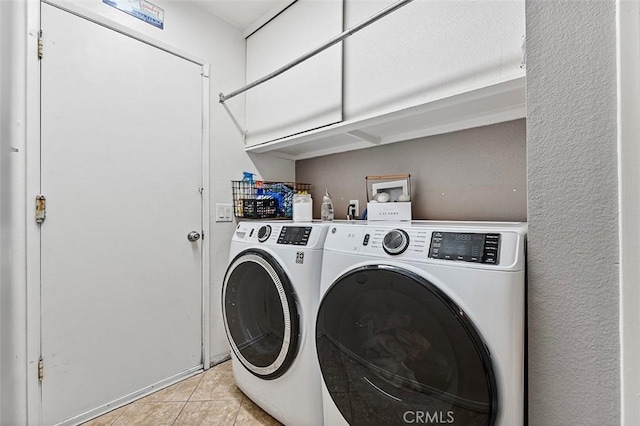 7669 Granby Ave, Rancho Cucamonga, CA 91730 - washroom featuring washer and dryer, light tile patterned flooring, and cabinet space