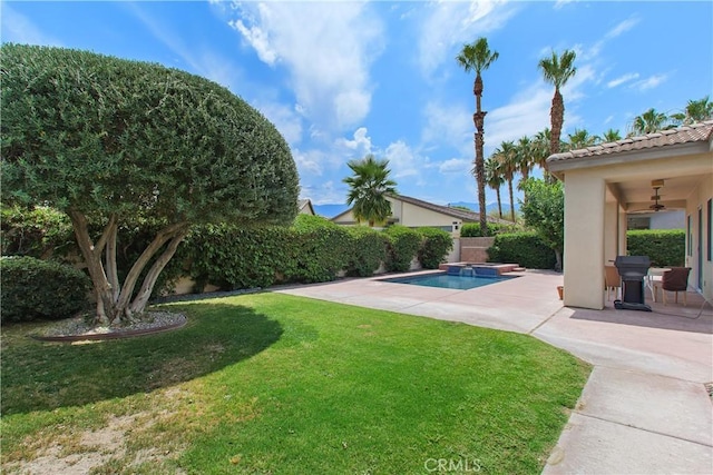 69635 Valle De Costa, Cathedral City, CA 92234 - view of yard with ceiling fan, a patio area, and a pool with connected hot tub