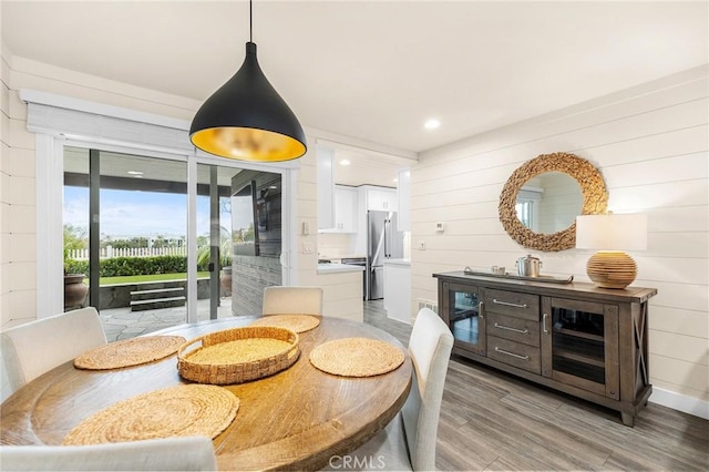 4735 Sunny Hills Rd, Oceanside, CA 92056 - dining area with light wood-type flooring, wood walls, and recessed lighting