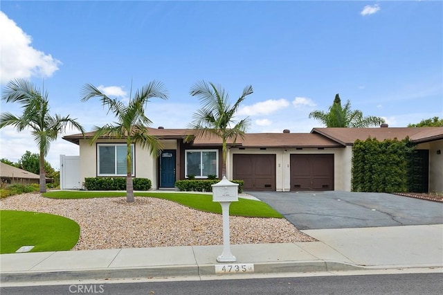 4735 Sunny Hills Rd, Oceanside, CA 92056 - ranch-style home featuring an attached garage, driveway, and stucco siding
