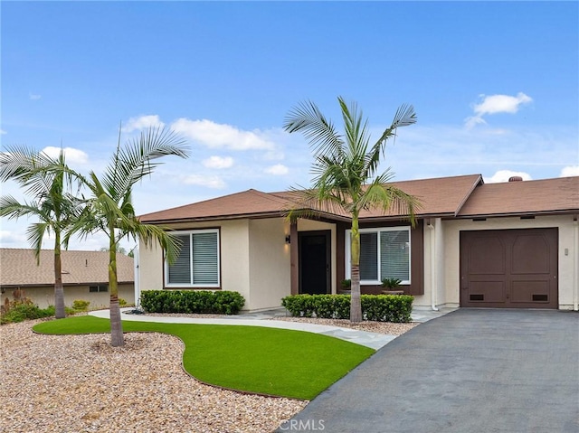 4735 Sunny Hills Rd, Oceanside, CA 92056 - single story home featuring a garage, stucco siding, and asphalt driveway