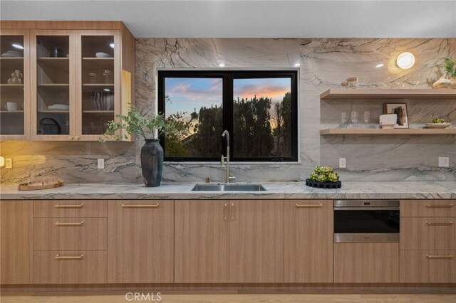 721 Wilson Ct, Burbank, CA 91501 - kitchen with a sink, modern cabinets, oven, light stone countertops, and light brown cabinetry