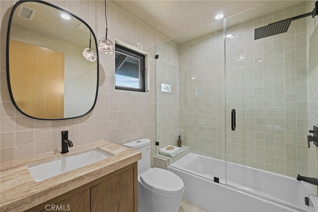 721 Wilson Ct, Burbank, CA 91501 - bathroom featuring tile walls, vanity, toilet, bath / shower combo with glass door, and tasteful backsplash
