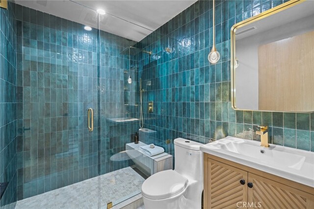 721 Wilson Ct, Burbank, CA 91501 - bathroom featuring tile walls, toilet, a stall shower, and vanity