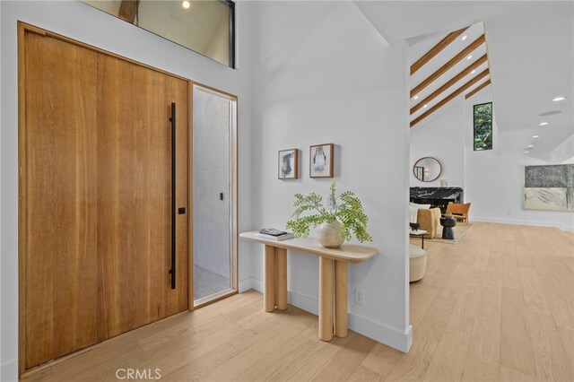 721 Wilson Ct, Burbank, CA 91501 - entrance foyer with wood finished floors, high vaulted ceiling, recessed lighting, beam ceiling, and baseboards