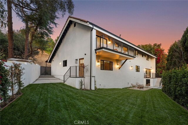721 Wilson Ct, Burbank, CA 91501 - back of house at dusk with a balcony, stucco siding, and a patio