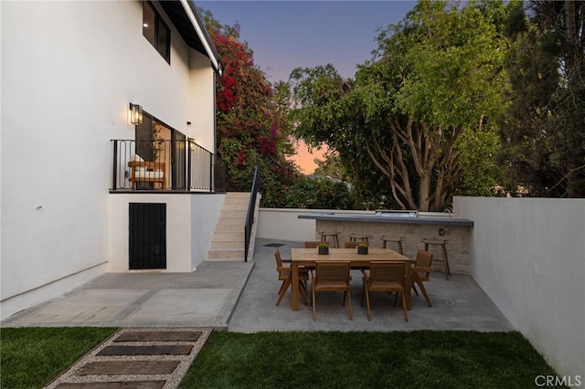 721 Wilson Ct, Burbank, CA 91501 - patio terrace at dusk with stairway, a patio, and outdoor dining area