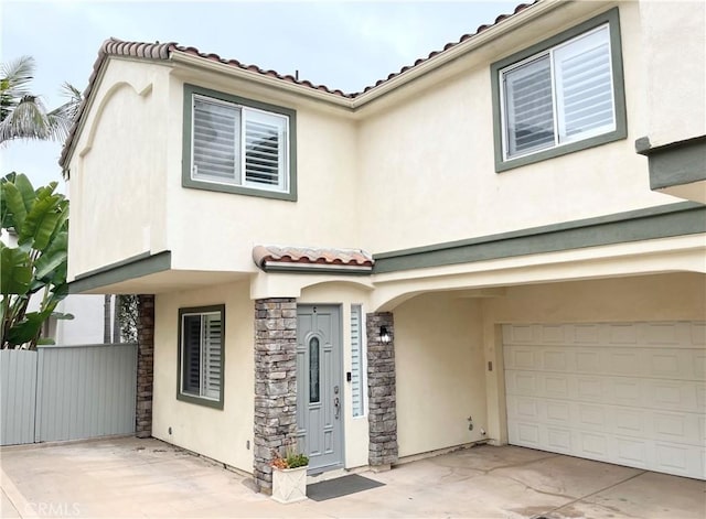 2223 Grant Ave Unit C, Redondo Beach, CA 90278 - view of front of property with a tiled roof, stucco siding, stone siding, a garage, and driveway