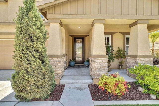 34253 Mazarine Dr, Temecula, CA 92592 - view of exterior entry with board and batten siding, stone siding, stucco siding, and a garage