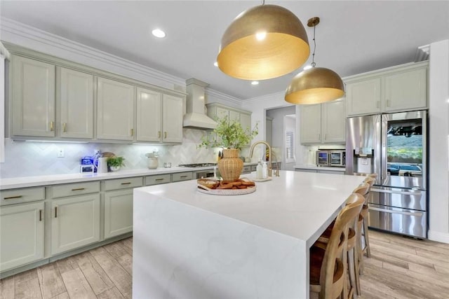 34253 Mazarine Dr, Temecula, CA 92592 - kitchen featuring stainless steel refrigerator with ice dispenser, premium range hood, light wood-style flooring, light countertops, and tasteful backsplash