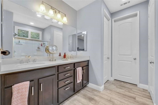 34253 Mazarine Dr, Temecula, CA 92592 - full bath featuring wood finished floors, double vanity, and baseboards