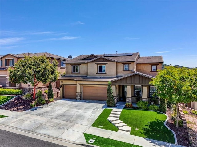 34253 Mazarine Dr, Temecula, CA 92592 - view of front facade featuring stucco siding, roof mounted solar panels, stone siding, an attached garage, and driveway