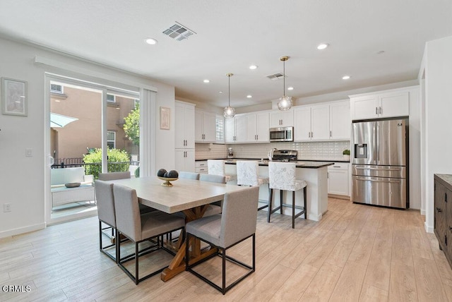 17065 Laurel Rd, Morgan Hill, CA 95037 - dining area with light wood finished floors and recessed lighting