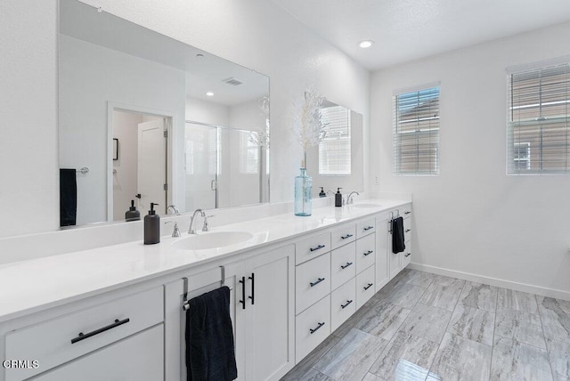 17065 Laurel Rd, Morgan Hill, CA 95037 - bathroom featuring double vanity, a shower stall, and recessed lighting
