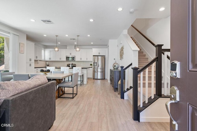 17065 Laurel Rd, Morgan Hill, CA 95037 - living room with light wood-type flooring, stairway, and recessed lighting