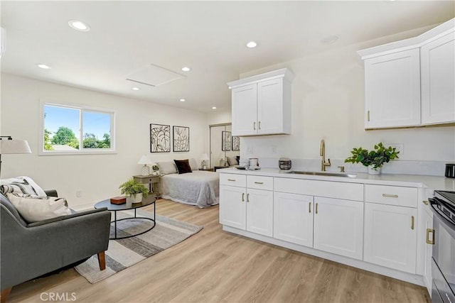 2380 Westcott Ave, Monterey Park, CA 91754 - kitchen with a sink, open floor plan, light countertops, white cabinetry, and light wood-style flooring