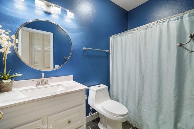 31332 Gatehouse Ct, Murrieta, CA 92563 - bathroom with vanity, toilet, tile patterned floors, baseboards, and a textured wall