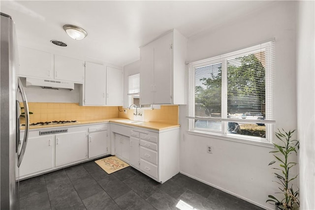 44246 Foxton Ave, Lancaster, CA 93535 - kitchen featuring under cabinet range hood, a sink, backsplash, light countertops, and white cabinetry