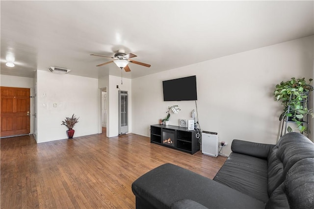 44246 Foxton Ave, Lancaster, CA 93535 - living room featuring a ceiling fan, wood finished floors, and a heating unit