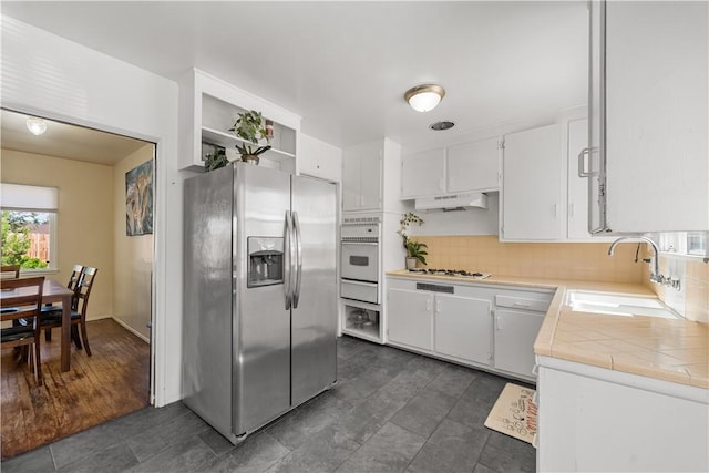 44246 Foxton Ave, Lancaster, CA 93535 - kitchen with white appliances, a sink, a warming drawer, under cabinet range hood, and white cabinetry