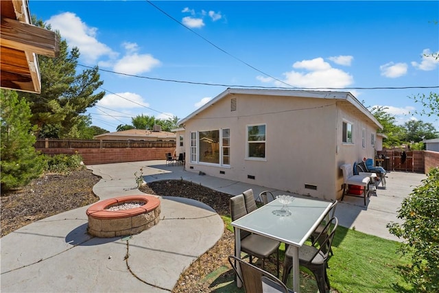 44246 Foxton Ave, Lancaster, CA 93535 - back of property with an outdoor fire pit, a patio, crawl space, and a fenced backyard