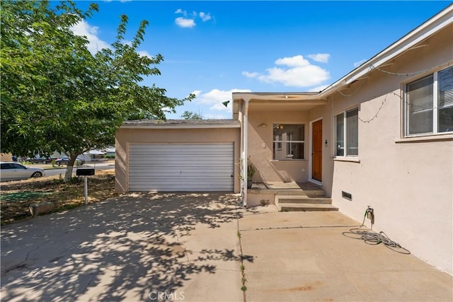 44246 Foxton Ave, Lancaster, CA 93535 - view of property exterior with concrete driveway, stucco siding, and a garage