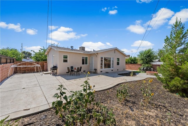 44246 Foxton Ave, Lancaster, CA 93535 - rear view of property with stucco siding, a fenced backyard, and a patio area