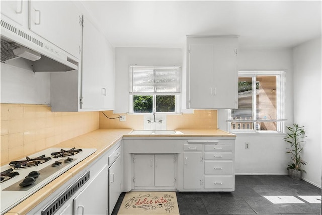 44246 Foxton Ave, Lancaster, CA 93535 - kitchen with under cabinet range hood, white gas stovetop, light countertops, a sink, and backsplash