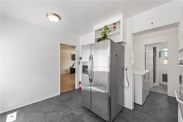 44246 Foxton Ave, Lancaster, CA 93535 - kitchen with stainless steel fridge with ice dispenser, washer and clothes dryer, open shelves, and white cabinetry