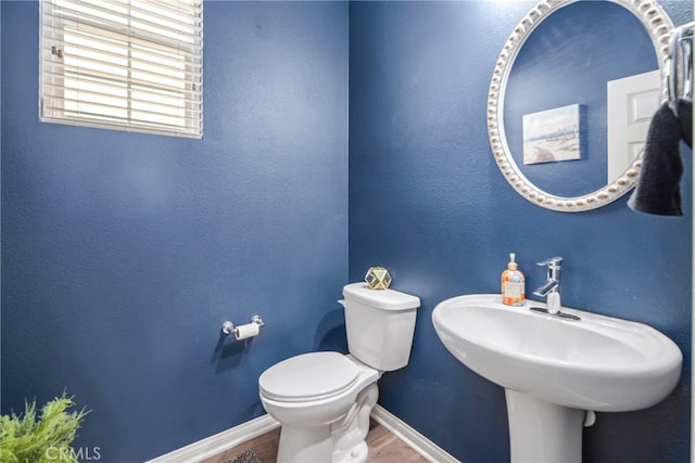 37436 Umbrella, Palmdale, CA 93551 - bathroom with baseboards, toilet, and wood finished floors