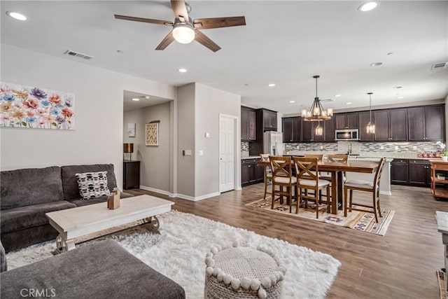 37436 Umbrella, Palmdale, CA 93551 - living area featuring ceiling fan, a chandelier, dark wood finished floors, recessed lighting, and baseboards
