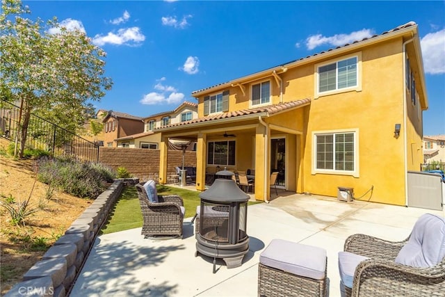 37436 Umbrella, Palmdale, CA 93551 - back of house with stucco siding, a patio area, a fenced backyard, and an outdoor living space with a fire pit