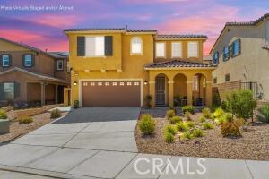 37436 Umbrella, Palmdale, CA 93551 - mediterranean / spanish house featuring driveway, an attached garage, and stucco siding