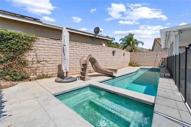 5191 Westerfield St, Jurupa Valley, CA 92509 - view of swimming pool featuring a water slide, a fenced backyard, and a patio area