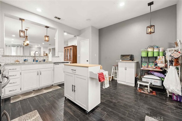 5191 Westerfield St, Jurupa Valley, CA 92509 - kitchen featuring dishwasher, tasteful backsplash, white cabinets, dark wood-style flooring, and recessed lighting