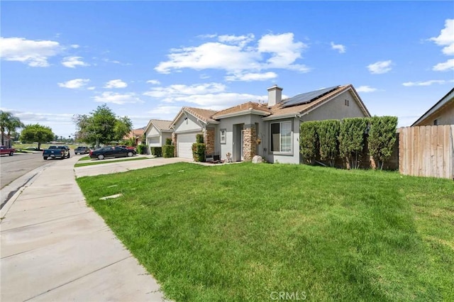 5191 Westerfield St, Jurupa Valley, CA 92509 - view of front of property featuring roof mounted solar panels, a garage, stucco siding, driveway, and a chimney