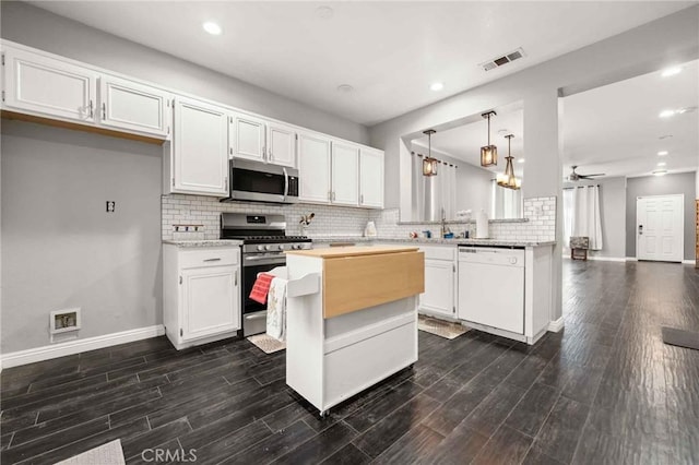 5191 Westerfield St, Jurupa Valley, CA 92509 - kitchen with stainless steel appliances, decorative backsplash, white cabinetry, recessed lighting, and ceiling fan