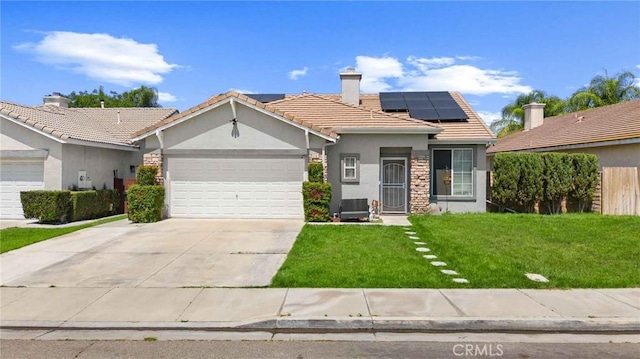 5191 Westerfield St, Jurupa Valley, CA 92509 - ranch-style home featuring stucco siding, a front lawn, a garage, roof mounted solar panels, and concrete driveway