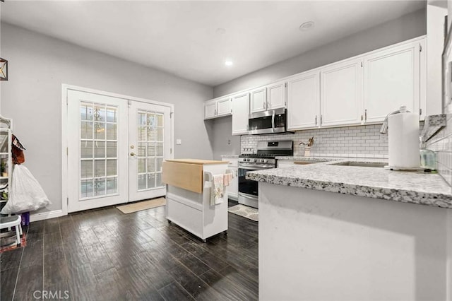 5191 Westerfield St, Jurupa Valley, CA 92509 - kitchen featuring stainless steel appliances, french doors, tasteful backsplash, white cabinetry, and light stone counters