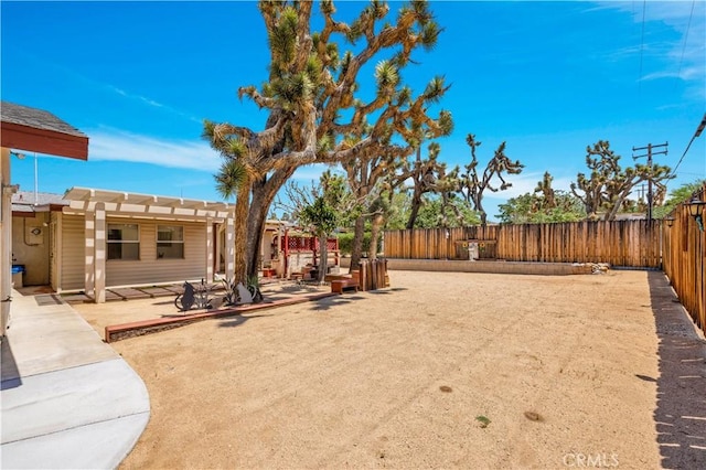 7608 Shawnee Trl, Yucca Valley, CA 92284 - fenced backyard with a patio and a pergola