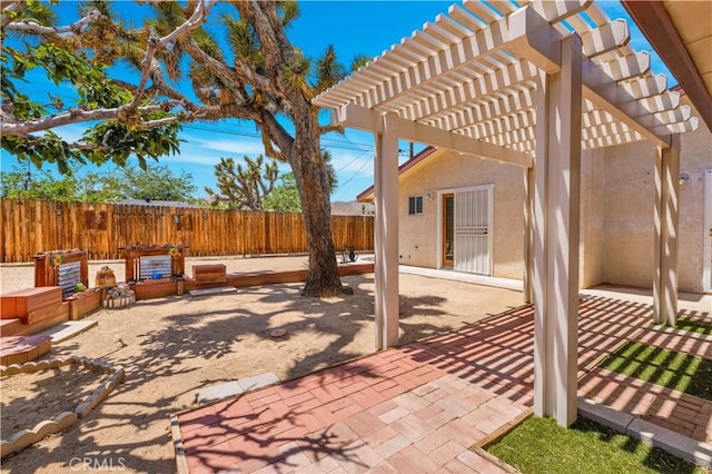 7608 Shawnee Trl, Yucca Valley, CA 92284 - fenced backyard with a patio and a pergola