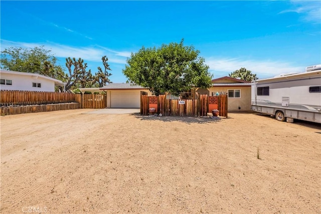 7608 Shawnee Trl, Yucca Valley, CA 92284 - back of property featuring driveway and a garage