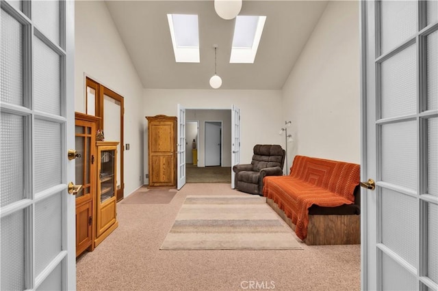 7608 Shawnee Trl, Yucca Valley, CA 92284 - living area featuring light colored carpet, a skylight, and lofted ceiling